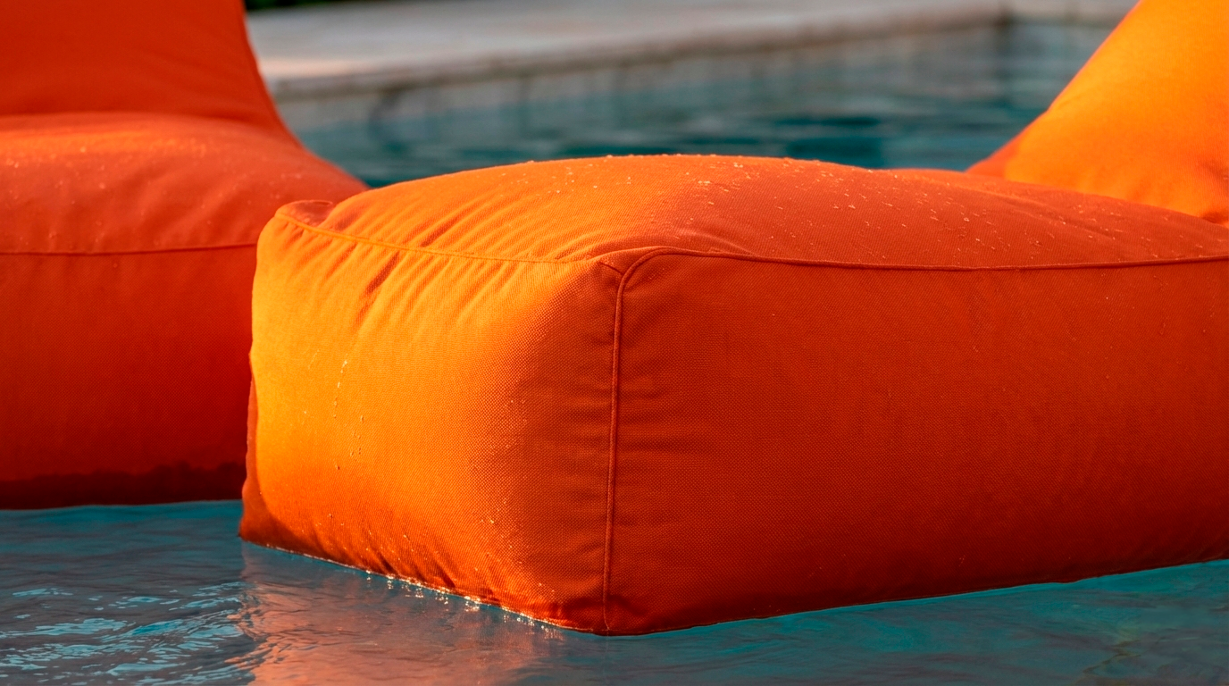Close-up of orange inflatable pool float by a pool